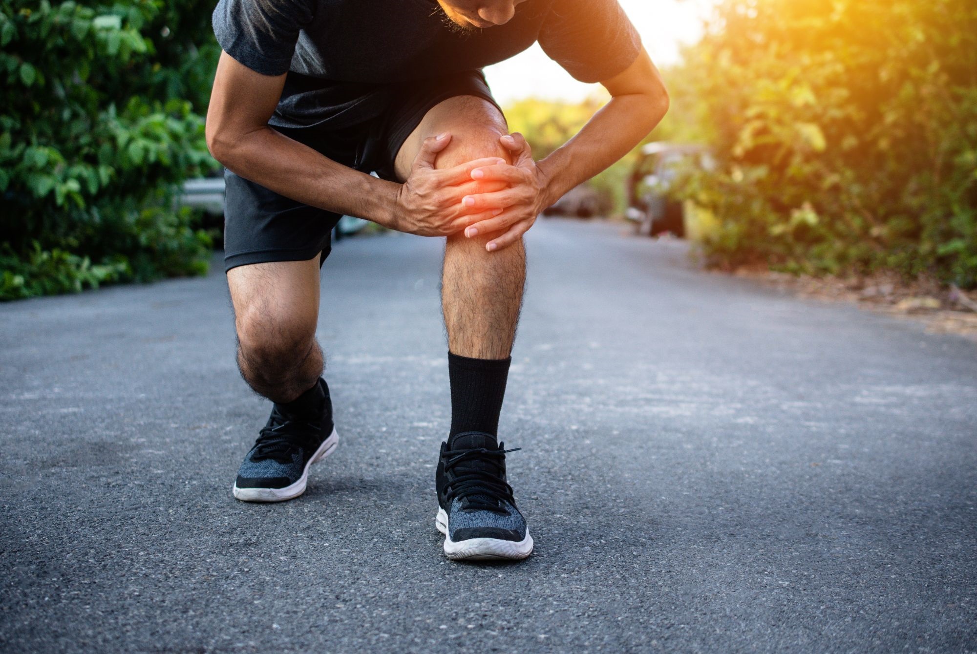 A man suffering from knee pain after running.